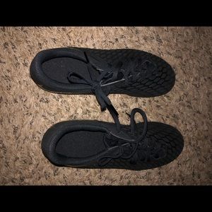 Black Nike Hypervenom soccer cleats .